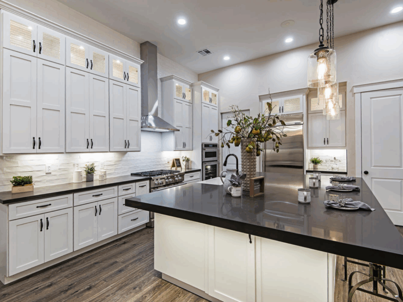 Luxury kitchen with custom hardwood flooring and tile backsplash