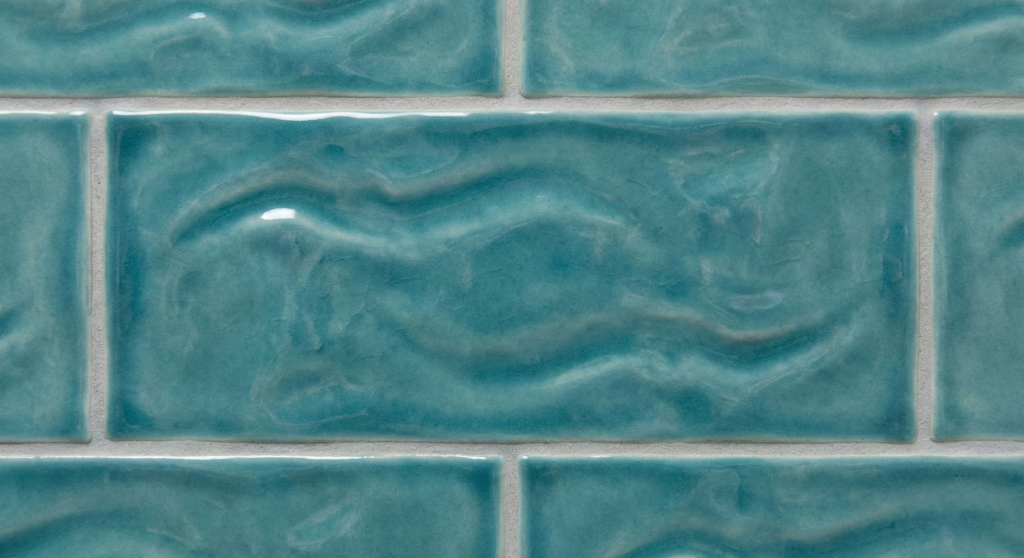 Close-up detail of glossy, turquoise wavy ceramic tiles perfect for a Solana Beach coastal home design.