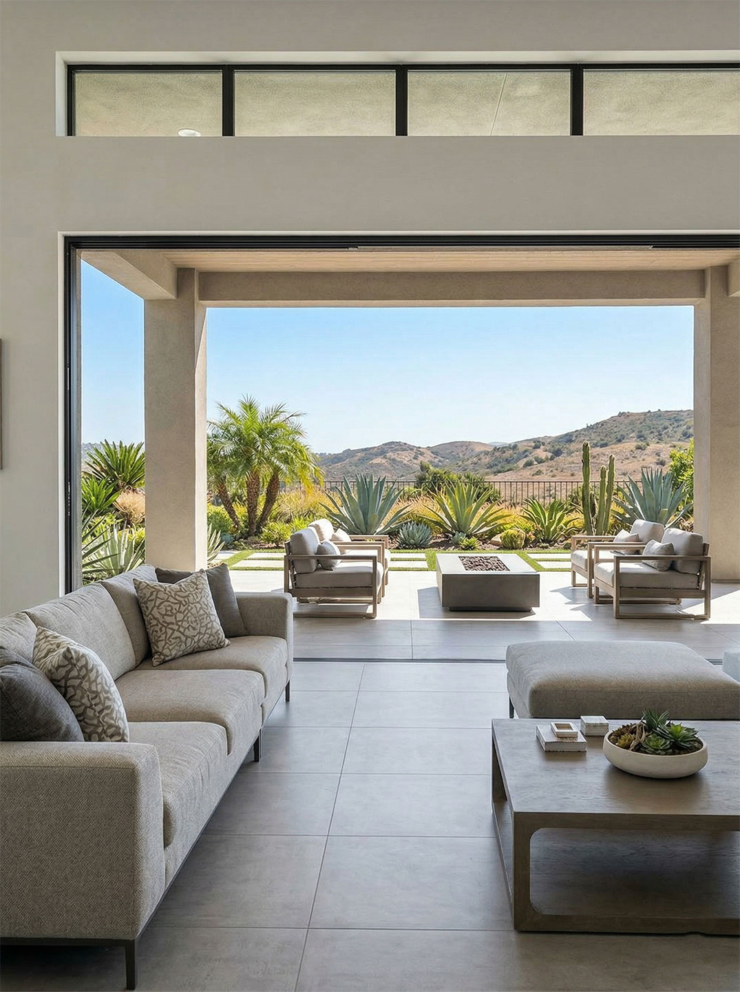Modern indoor-outdoor living area in a Del Sur home featuring large format tile installed by Charmet Tile